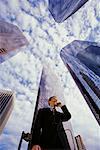 Businessman Using Cell Phone By Office Towers Los Angeles, California, USA