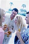 Group of People with Drinks Laughing Outdoors