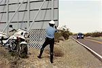 Police Officer with Motorcycle at Radar Trap