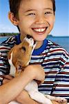 Portrait of Boy with Dog Licking Face