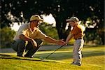 Father and Son Playing Golf on Golf Course