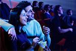 Couple Watching Movie in Theater Laughing