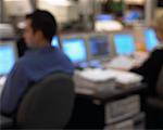 Blurred View of People at Computers in Stock Market Trading Room