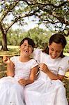 Two Girls Wearing Dresses Laughing Outdoors