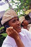 Man Using Cell Phone, Laughing Outdoors Indonesia