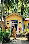 Woman Walking by Colorful House Betapur, Andaman Islands, India