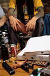 Men Sitting on Sofa with Football Pizza Boxes and Beer Bottles on Table