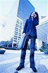 Businesswoman Standing Outdoors Using Cell Phone