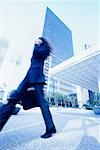 Businesswoman Walking Outdoors Using Cell Phone