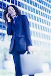 Businesswoman Standing Outdoors Using Cell Phone