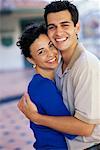 Portrait of Couple Embracing and Smiling Outdoors