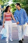 Couple Walking Outdoors Carrying Shopping Bags