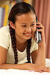 Girl Lying on Bed, Using Phone Smiling