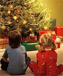 Boy and Girl by Christmas Tree