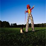 Man on Stilts With Dog