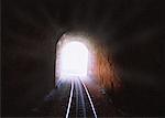 Train Tracks Leading Through Tunnel