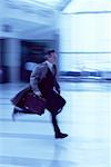 Businessman Running Through Airport