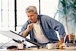 Man Sitting at Drafting Table