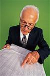 Humorous Businessman Reading Financial Papers