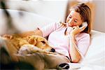 Woman Using Phone on Sofa