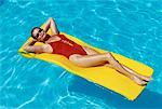 Woman Lying on Air Mattress in Swimming Pool
