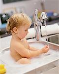 Baby Bathing In Kitchen Sink
