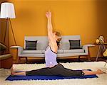 Woman Practising Yoga in Her Living Room