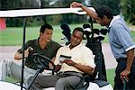 Men in Golf Cart Talking with Friend