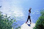 Woman Stretching on Dock