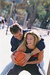 Couple Outdoors Playing Basketball