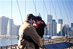 Young Couple Hugging on Bridge