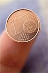 Finger with Euro Cent Coin
