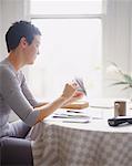 Woman Working at Kitchen Table