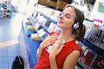 Teenager Listening to Music In Store