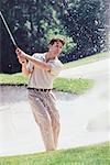 Man Golfing Out of Sand Trap