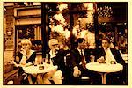 People Sitting at Sidewalk Cafe Paris, France