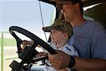 Father and Son Driving Combine