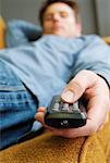 Man Lying Down Holding Remote Control