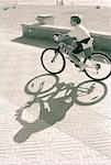 Boy Riding Bike on Beach