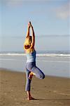 Woman Doing Yoga on the Beach