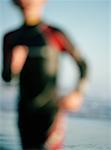 Child in Wetsuit on Beach