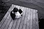Boy Sitting on Dock Using Laptop