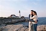 Couple Hugging by Lighthouse