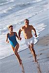 Couple Running on Beach