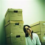 Woman Leaning on Stack of Boxes