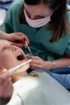 Girl Being Examined by Dentists