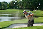 Golfer Hitting Ball in Sand Trap