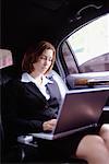 Woman Using Laptop in Limo