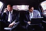 Businessmen in Back of Limousine