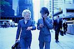 Businesswomen with Cell Phone on Sidewalk